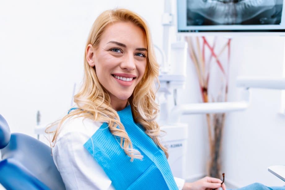 woman smiling in a dental chair